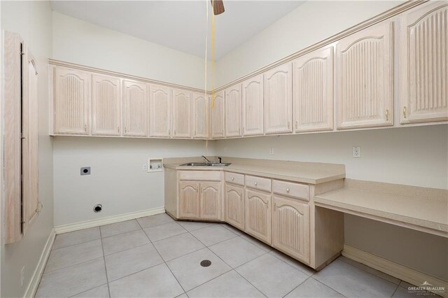 washroom with electric dryer hookup, cabinets, sink, hookup for a washing machine, and light tile patterned flooring