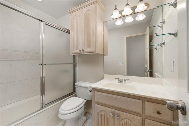 full bathroom with vanity, toilet, and shower / bath combination with glass door