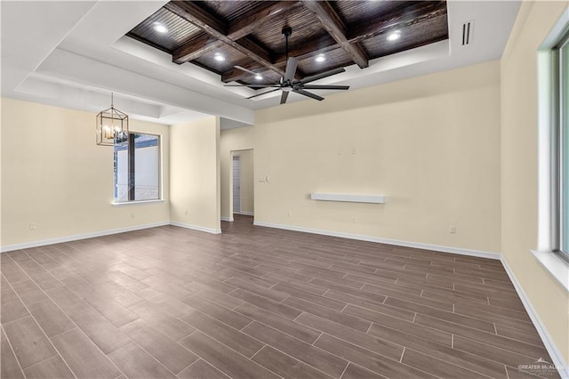 empty room with beam ceiling, coffered ceiling, dark hardwood / wood-style flooring, wood ceiling, and ceiling fan with notable chandelier