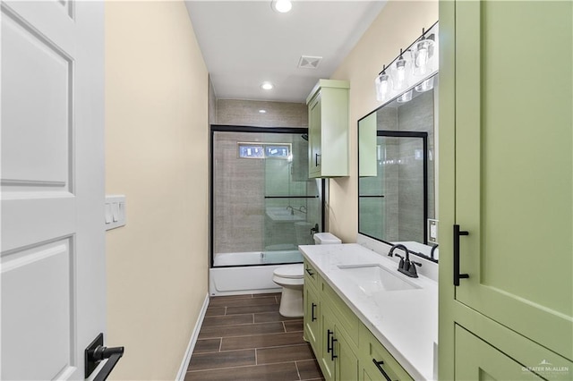 full bathroom with shower / bath combination with glass door, vanity, and toilet