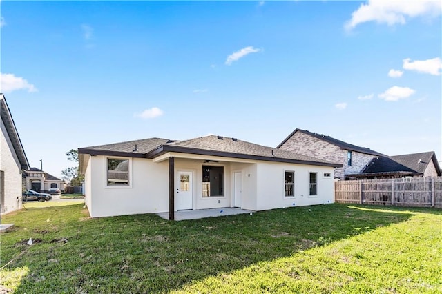 back of property featuring a patio area and a lawn