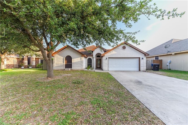 2121 Kingsborough Ave, Mcallen, TX 78504 - view of front facade with a garage, concrete driveway, and brick siding