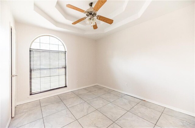 2121 Kingsborough Ave, Mcallen, TX 78504 - unfurnished room featuring a raised ceiling, healthy amount of natural light, light tile patterned flooring, and ceiling fan
