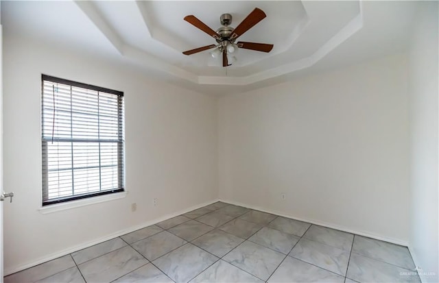 2121 Kingsborough Ave, Mcallen, TX 78504 - empty room featuring a tray ceiling, plenty of natural light, and a ceiling fan