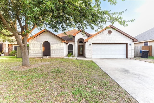 2121 Kingsborough Ave, Mcallen, TX 78504 - view of front of home with brick siding, an attached garage, and concrete driveway
