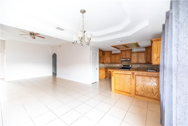 2121 Kingsborough Ave, Mcallen, TX 78504 - kitchen featuring a raised ceiling, open floor plan, stainless steel electric range, a peninsula, and tasteful backsplash