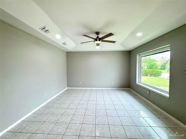 unfurnished room featuring recessed lighting, light tile patterned floors, visible vents, a ceiling fan, and a tray ceiling