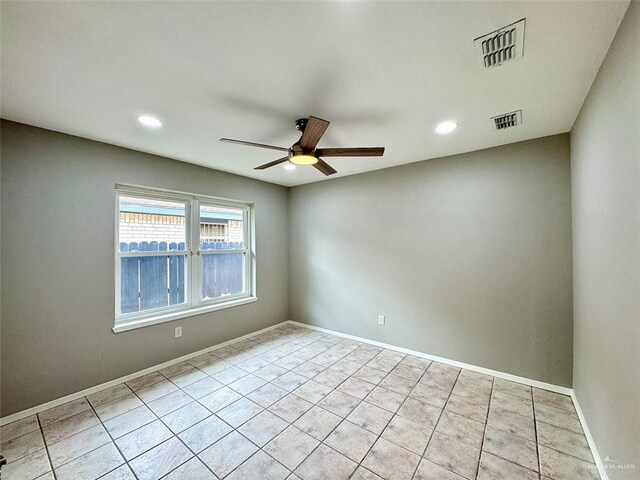 unfurnished room with light tile patterned floors, visible vents, and ceiling fan