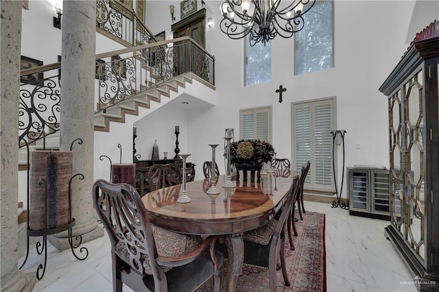 dining room featuring a towering ceiling and a chandelier