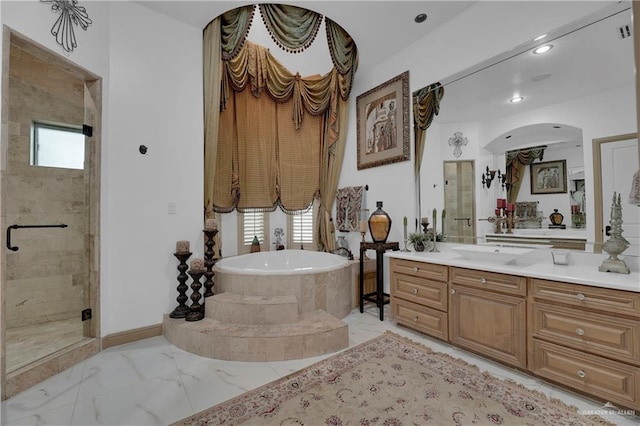 bathroom with shower with separate bathtub and vanity