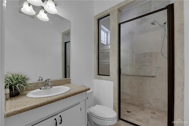 bathroom with toilet, vanity, and walk in shower