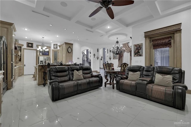 living room featuring beam ceiling, ceiling fan with notable chandelier, and coffered ceiling