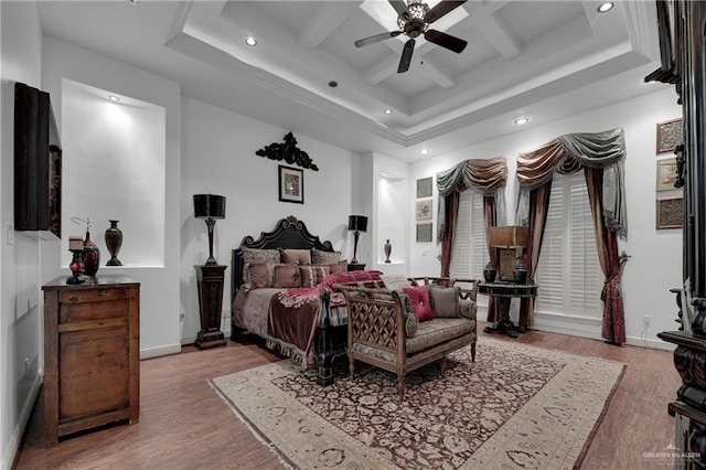 bedroom featuring ceiling fan, beam ceiling, light wood-type flooring, and coffered ceiling