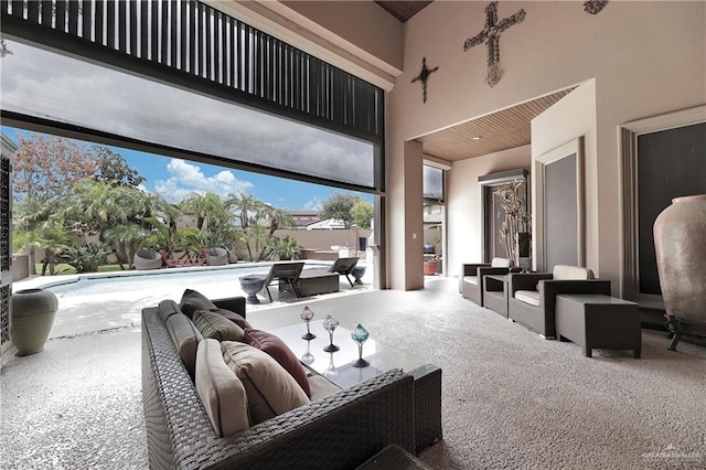 cinema room featuring a towering ceiling and carpet floors