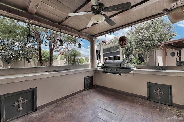 view of patio featuring an outdoor kitchen, ceiling fan, sink, and grilling area