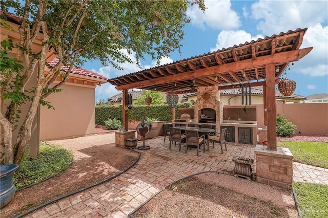 view of patio / terrace with an outdoor kitchen and a pergola