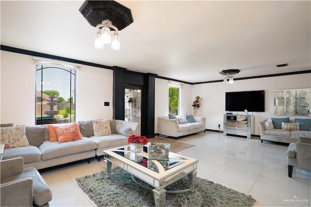 living room with a chandelier, light tile patterned floors, and ornamental molding