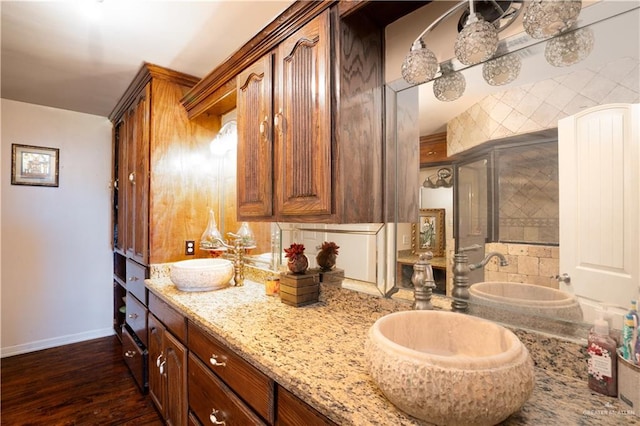 bathroom with hardwood / wood-style flooring, vanity, and backsplash