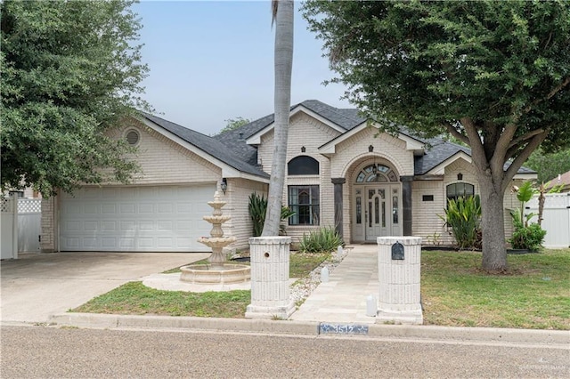 3512 W Gardenia Ave, Mcallen, TX 78501 - view of front facade featuring driveway, roof with shingles, a garage, and brick siding