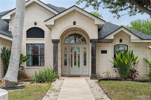 3512 W Gardenia Ave, Mcallen, TX 78501 - doorway to property with a chimney, brick siding, and a shingled roof