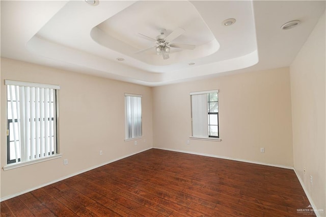 3512 W Gardenia Ave, Mcallen, TX 78501 - spare room featuring a ceiling fan, baseboards, hardwood / wood-style flooring, and a tray ceiling