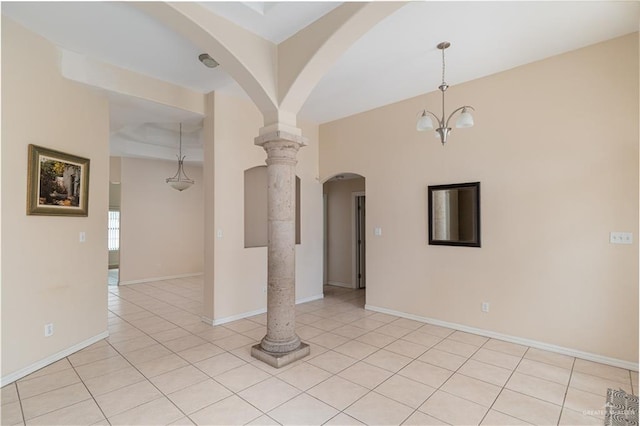 3512 W Gardenia Ave, Mcallen, TX 78501 - empty room featuring ornate columns, light tile patterned floors, baseboards, and arched walkways