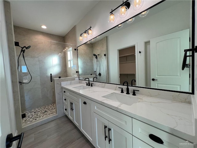 bathroom with an enclosed shower, vanity, and hardwood / wood-style floors