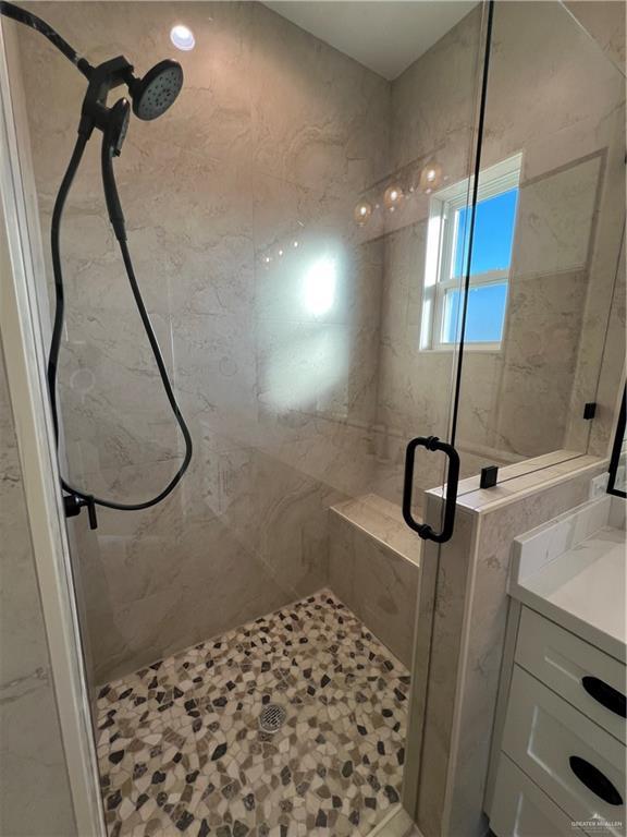 bathroom featuring a shower with shower door