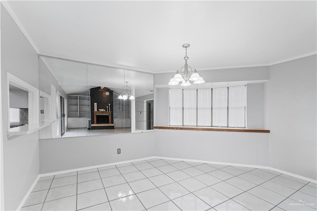 unfurnished dining area featuring a notable chandelier, ornamental molding, light tile patterned floors, and a brick fireplace