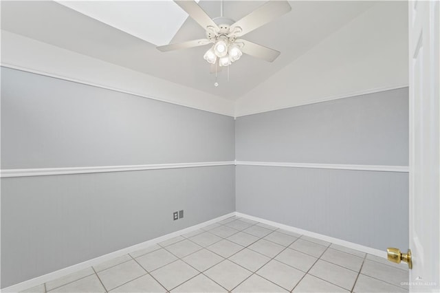 unfurnished room featuring vaulted ceiling, ceiling fan, and light tile patterned flooring