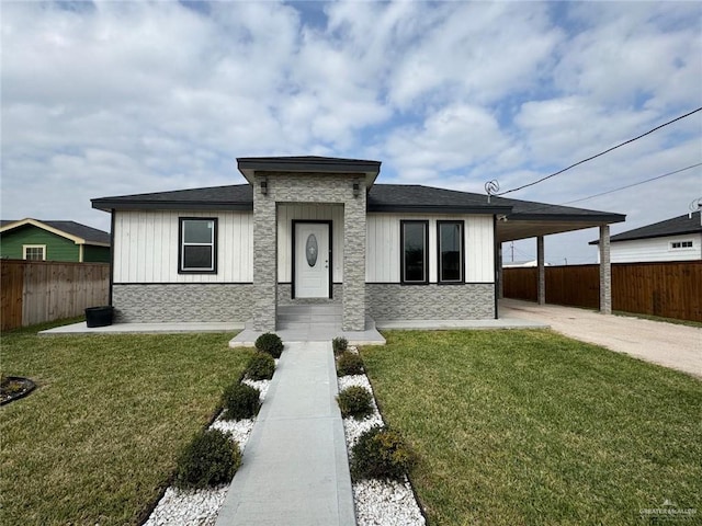 view of front of house with an attached carport, fence, concrete driveway, stone siding, and a front lawn