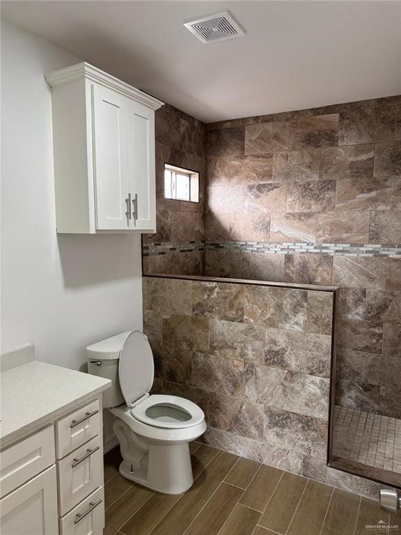 full bath with visible vents, toilet, wood tiled floor, walk in shower, and vanity