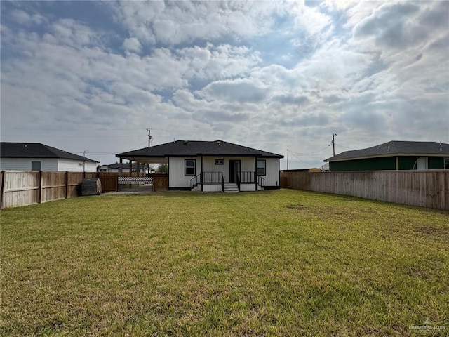 back of property with a yard and a fenced backyard