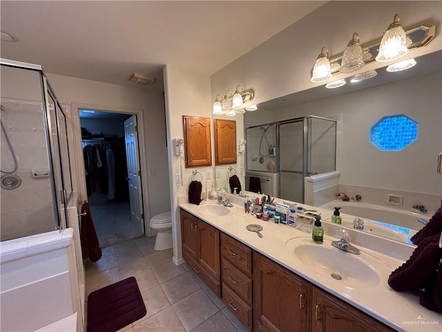233 Karen Dr, Alamo, TX 78516 - bathroom with a stall shower, double vanity, tile patterned flooring, a spacious closet, and a bath