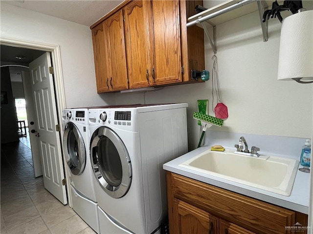 233 Karen Dr, Alamo, TX 78516 - laundry room with washing machine and clothes dryer, cabinet space, and light tile patterned flooring