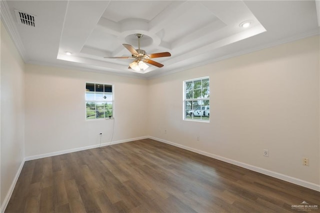 unfurnished room featuring a raised ceiling, crown molding, and dark hardwood / wood-style flooring