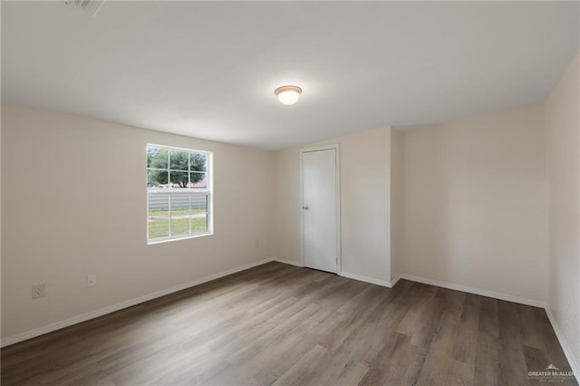 empty room with wood-type flooring