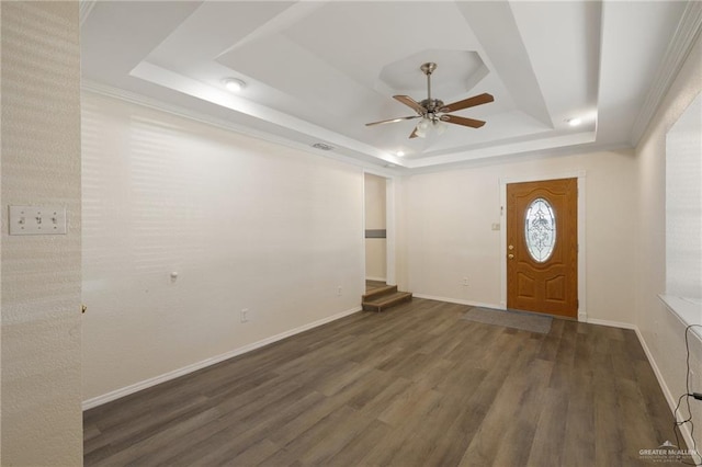 entryway with a raised ceiling, ceiling fan, and dark hardwood / wood-style flooring