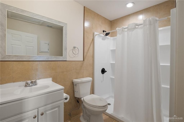 bathroom with toilet, vanity, tile walls, and walk in shower