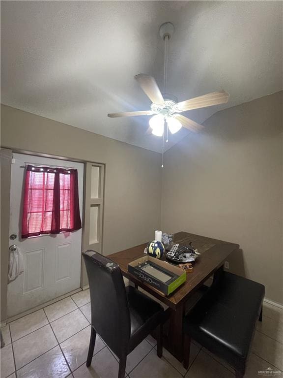 tiled dining space with ceiling fan