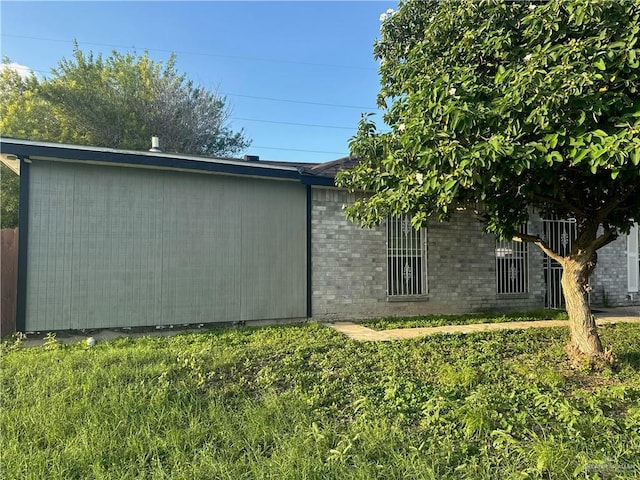 view of home's exterior with a yard