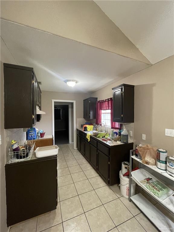 kitchen with light tile patterned floors and sink