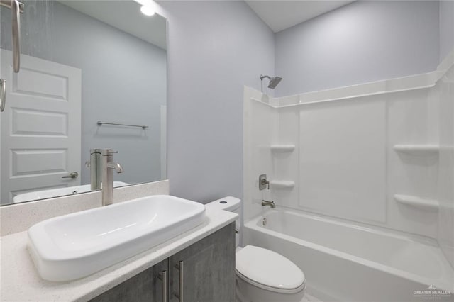 full bathroom featuring bathing tub / shower combination, vanity, and toilet