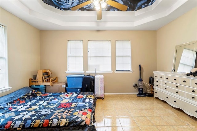 1123 E Champion St, Edinburg, TX 78539 - bedroom with light tile patterned floors, baseboards, a ceiling fan, and a raised ceiling