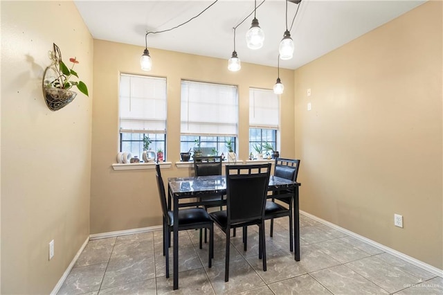 1123 E Champion St, Edinburg, TX 78539 - tiled dining room featuring healthy amount of natural light and baseboards