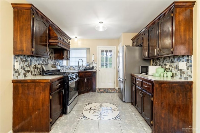 1123 E Champion St, Edinburg, TX 78539 - kitchen with stainless steel appliances, backsplash, light tile patterned flooring, dark brown cabinets, and a sink