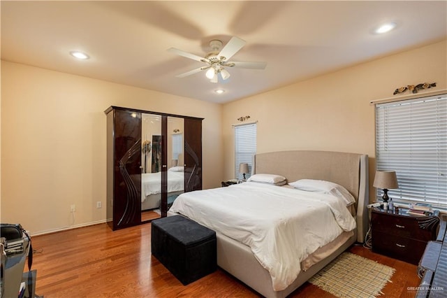 bedroom with hardwood / wood-style flooring and ceiling fan