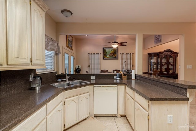 kitchen with kitchen peninsula, ceiling fan, sink, light tile patterned floors, and dishwasher