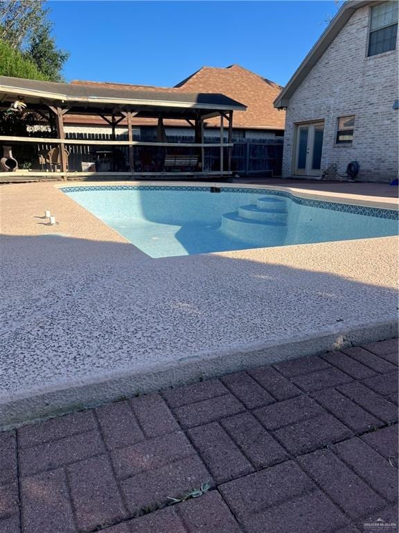 view of pool featuring french doors and a patio