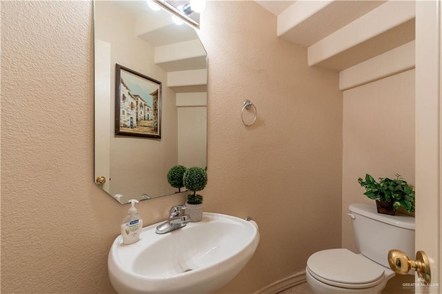 bathroom with toilet and sink